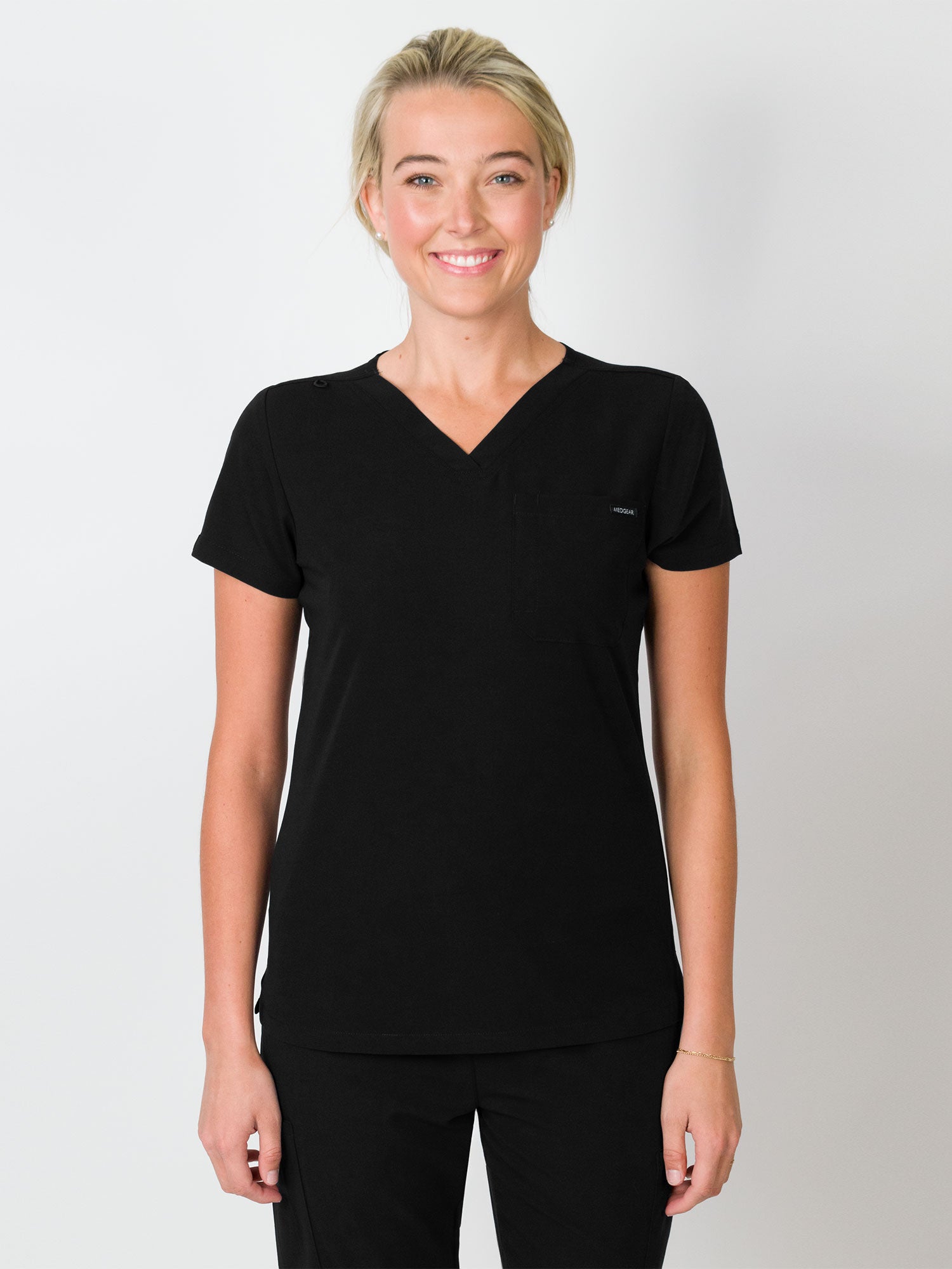 Black scrubs top with a single chest pocket and V-neck.