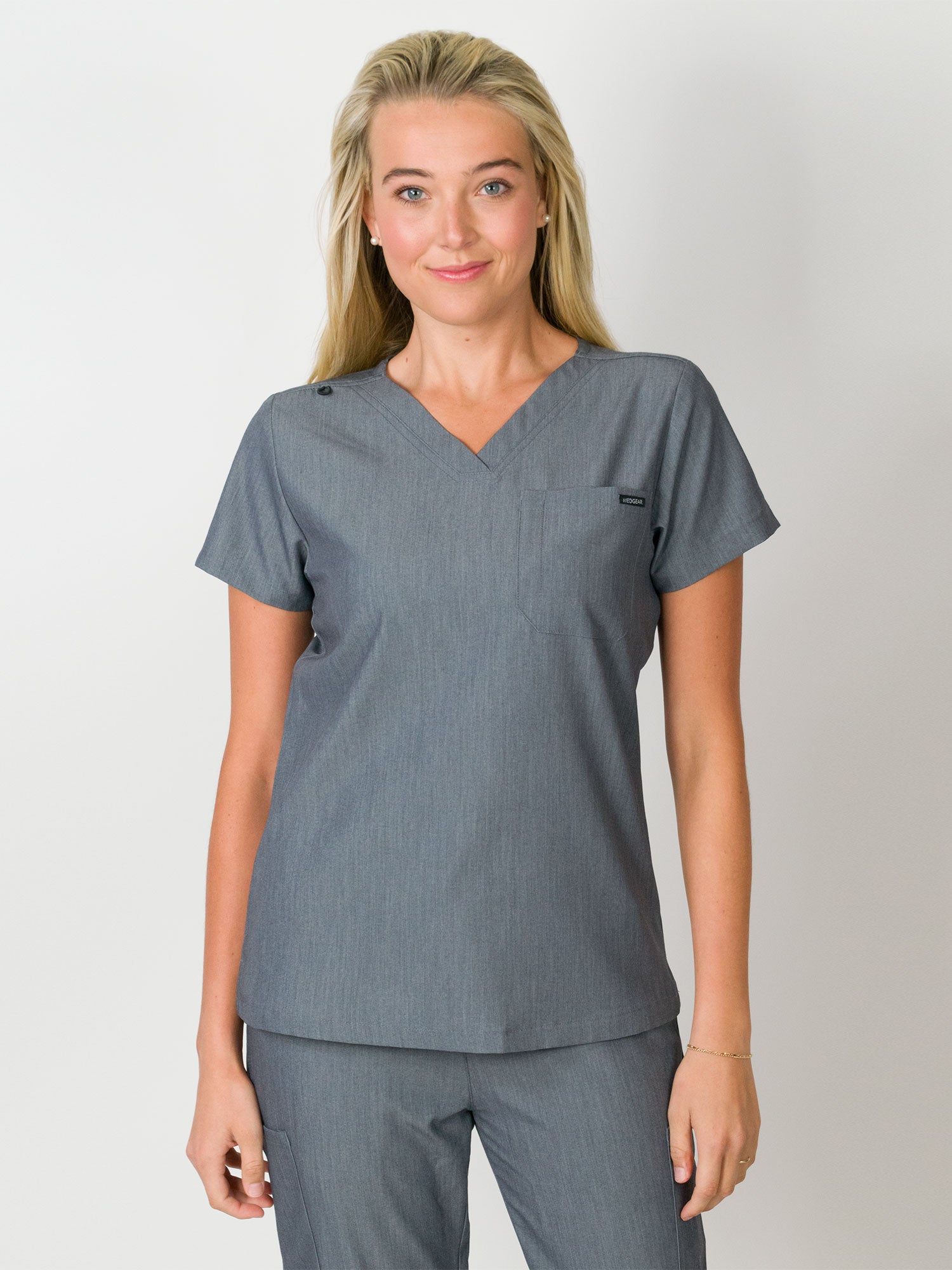 Light grey scrubs top with a single chest pocket and V-neck.