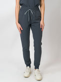 Gray mid-rise slim jogger scrub pants with Medgear branding, an elastic waistband and drawstring, with multiple pockets.