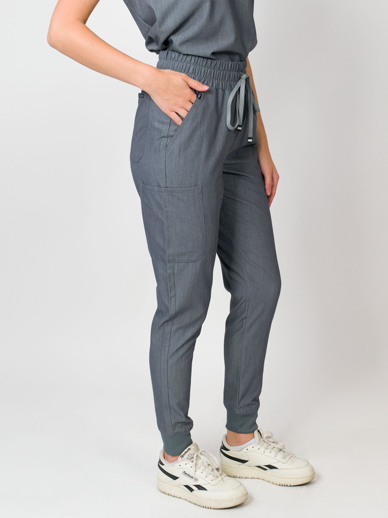 Heather grey mid-rise slim jogger Medgear scrub pants with an elastic waistband and drawstring, with multiple pockets.