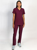 Scrub set in burgundy color, V-neck top with three bottom front patch pockets and a matching burgundy pant with multiple pockets.