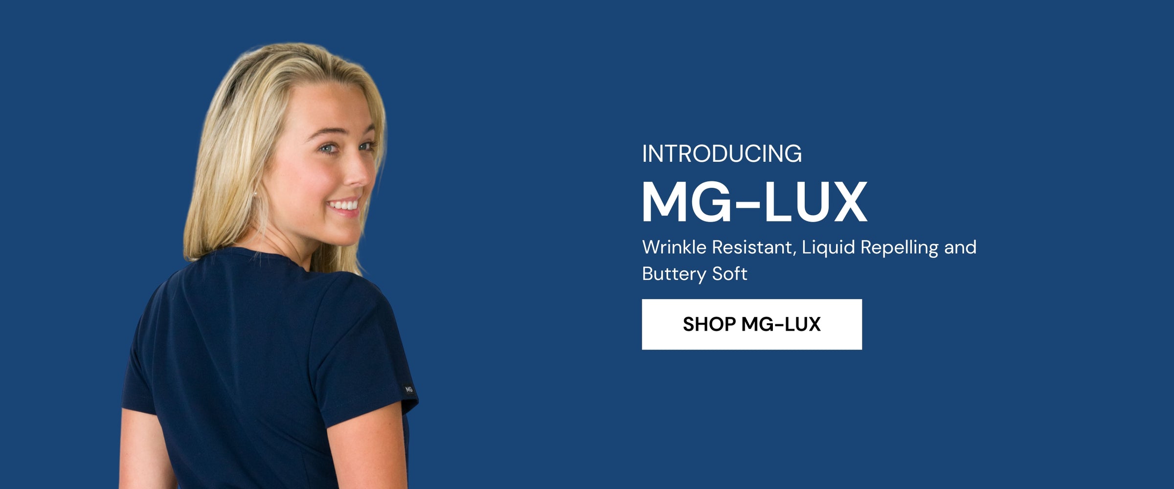 A woman modeling a scrubs top from the MG-LUX collection which is buttery soft, liquid repelling and wrinkle resistant