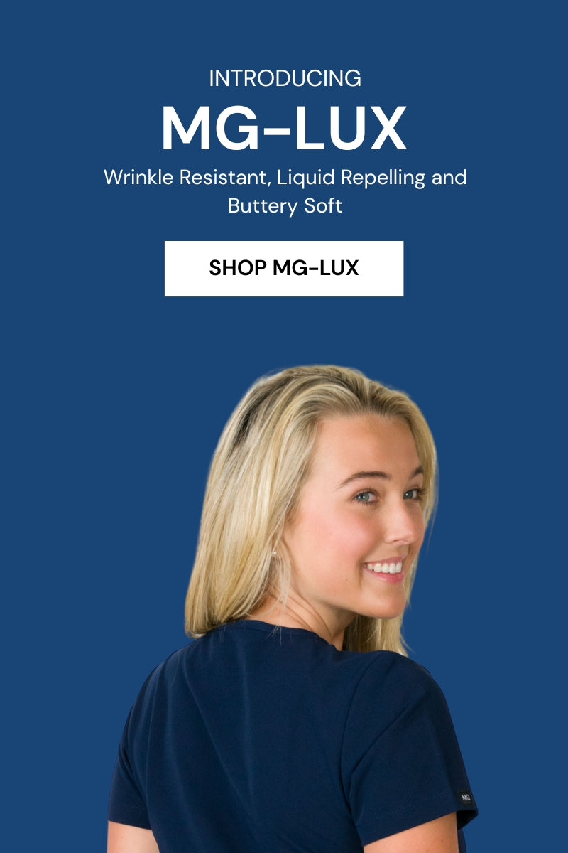 A woman modeling a scrubs top from the MG-LUX collection which is buttery soft, liquid repelling and wrinkle resistant