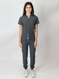 Grey scrub jumpsuit with a mandarin collar, short sleeves, and elastic jogger cuffs. The jumpsuit has multiple pockets and a zipper front.