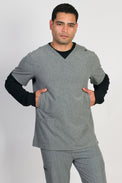 A male wearing a gray scrubs top with a classic V-neckline and 5 pockets, including handwarmers on the sides.