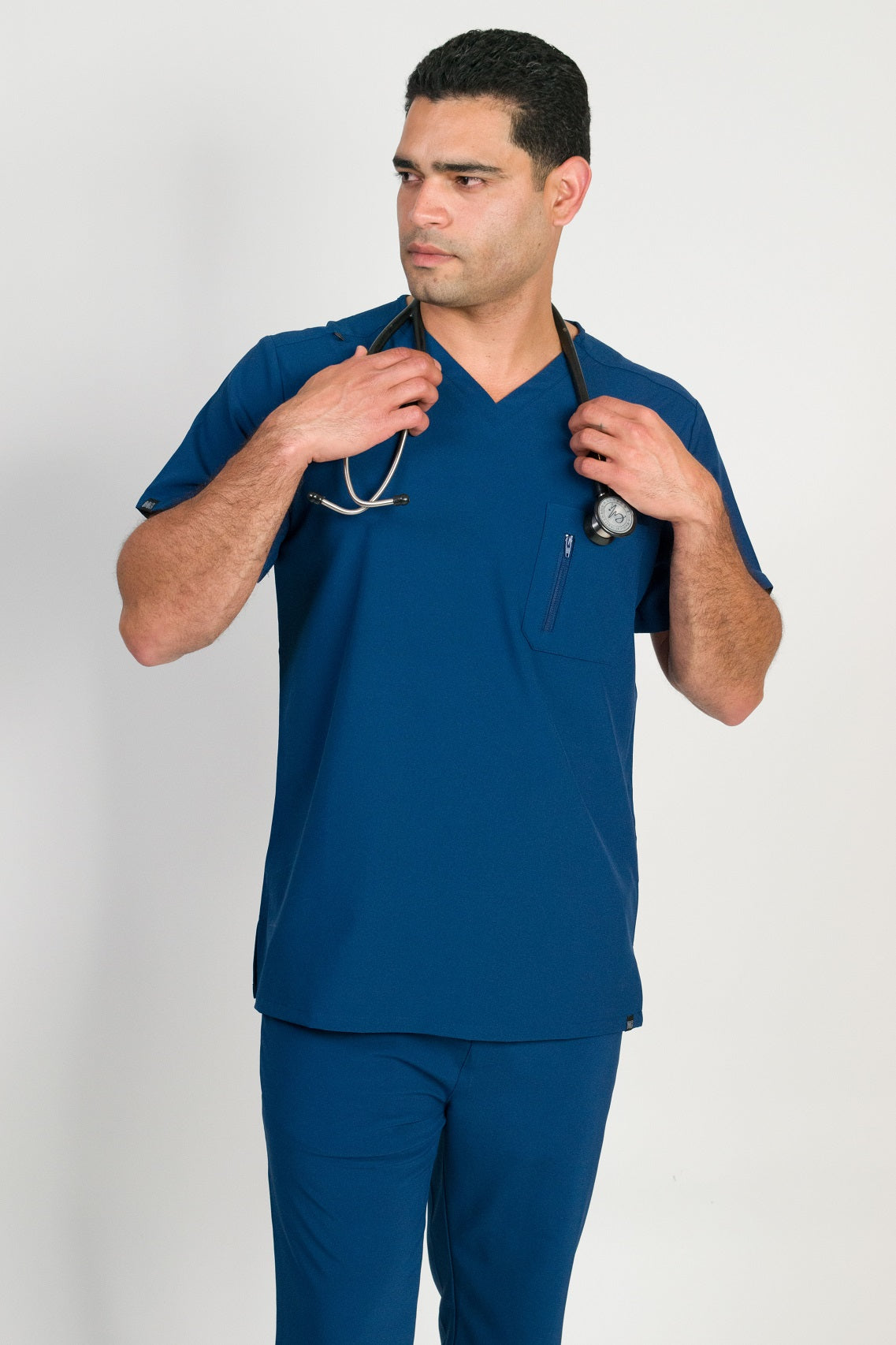 Blue short-sleeve V-neck scrubs top with two chest pockets.